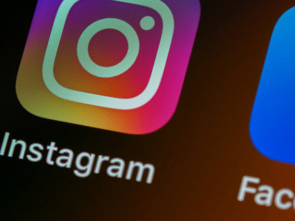 The Instagram app icon on a smartphone screen with other app icons